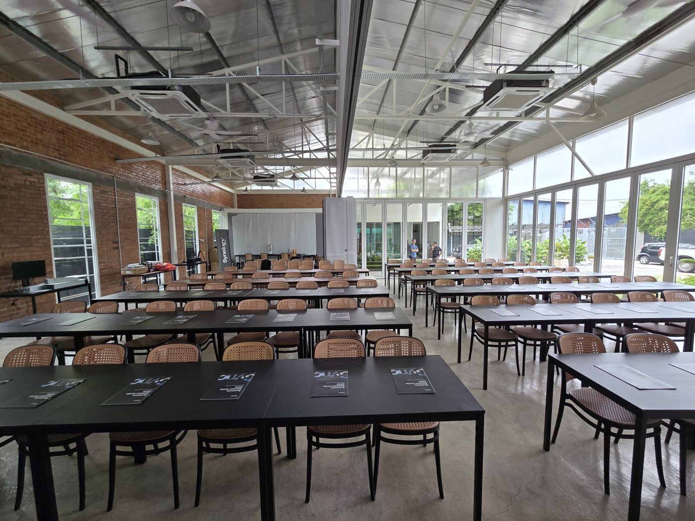 The room set up before doors opened — and the live demo stations, Synology NAS units out on the floor.