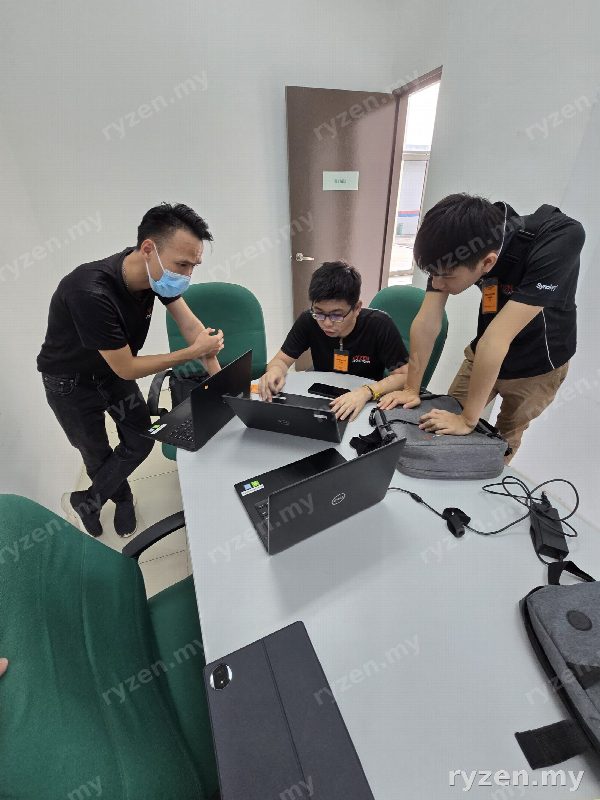 Three Ryzen engineers configuring equipment together on a client site